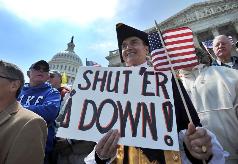 Protesters demonstrate in front of the Capitol Hill in Washington, DC, on April 6, 2011 urging for government spending cut.